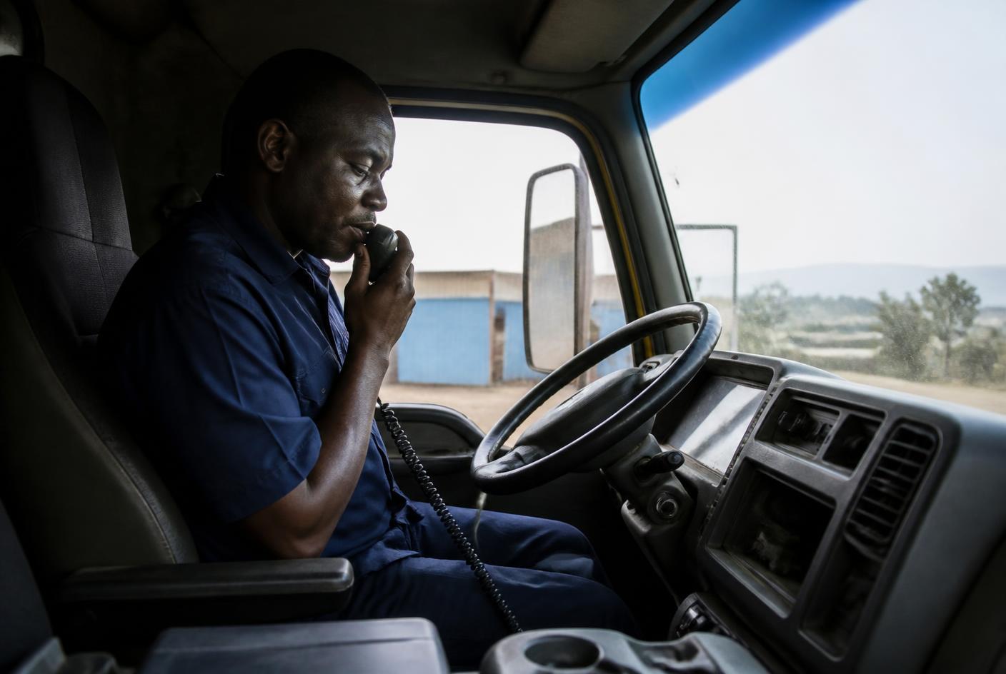 Driver completing a breath test on an in-cab interlock handset before starting the engine